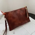 Vintage brown faux-leather envelope clutch bag with tassel detail and wristlet strap - Brown Geometric Embossing