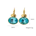 Elegant gold-plated titanium steel earrings with oval light blue crystal accents. - Peacock Blue
