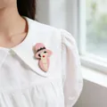 Cute cartoon acrylic brooch featuring a lady in a pink hat pinned to a white blouse. - Pink