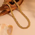 Dettaglio della collana intrecciata a tre strati d'oro su supporto di legno - Collana Oro