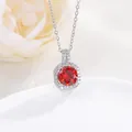 Macro shot of silver perfume bottle pendant with red zircon and white diamonds - Garnet Red