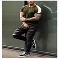 Close-up detail of men's slim fit olive green sports T-shirt with white sleeve stripes - M / Army Green