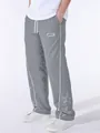 Close-up detail of grey men's high street sports pants with embroidered white stars - Light Gray