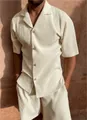 Detailed view of cream plissé texture on men's short sleeve shirt and shorts set - Beige