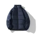 Detail view of a navy blue quilted puffer jacket laid flat on a clean white background - S / Dark Blue