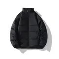 Front view of a minimalist black unisex winter padded puffer jacket with stand-up collar - S / Black