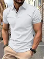 Detailed shot of a classic white slim-fit men's polo shirt worn in an outdoor setting - White