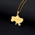 Close-up of gold Ukraine map pendant with HOME engraving on black textured background - HOME Lettering Map (金色项链J) / Gold