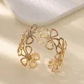 Detailed view of a gold-tone titanium steel bangle with hollowed-out daisy floral patterns. - Hollow Out Daisy Bangle (B1737) / Gold