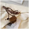 Detail shot of vintage brown suede mini crossbody purse with patterned ribbon strap - Style 1 / Brown