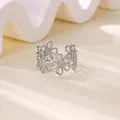 Detailed macro view of the hollow floral pattern on the silver titanium steel ring. - Continuous Daisy Hollow Ring (JZ7646) / Silver