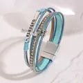 Close-up of bohemian multi-layer blue leather bracelet with rhinestone cross and magnetic clasp - Lake Blue