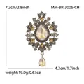 Elegante spilla vintage in vetro con pendente a goccia, strass e dettagli di misura - Oro Caffè - Champagne