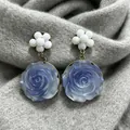 Vintage blue rose earrings with white floral studs presented on a soft gray knit background - Blue and White Rose Vintage Style Earrings (2606012)