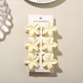 Set of six elegant pale yellow plumeria egg flower hair claw clips on display card - 4cm Frangipani Style / 6-Piece Set / Glossy Cream White / Bulk Packaging
