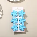 Set of six light blue matte plumeria flower hair claw clips displayed on a white card - 4cm Frangipani Style / 6-Piece Set / Matte Blue / Bulk Packaging