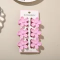Set of six elegant pink plumeria flower hair claw clips on a white display card - 3.5cm Glossy Five-Petal Style / Set of 6 / Pink / Bulk Packaging