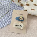 Niedliches Set handgemachter Kinder-Haarspangen mit Hunde-Stickerei und Fransen - Denim-Hund