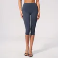 High-waisted dark grey yoga capris with a brushed finish for athletic fitness wear. - Dark Blue / S