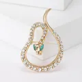 Elegant gold snake brooch accessory decorated with clear rhinestones and green crystal eyes - Western Rhinestone Snake Style (XH-1722)