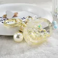 Golden keychain with transparent TV-shaped charm and large faux pearl - Noctilucent TV Style / Lemon Yellow