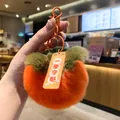 Close-up of a fuzzy orange persimmon plush keychain with a green leaf top and tag. - Persimmon Winning First Place
