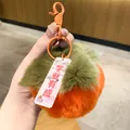 Macro detail of an orange plush persimmon keychain with a student success charm - Persimmon Academic Success