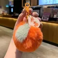 Detail of plush persimmon keychain with lucky tag and soft faux fur texture - Orange Great Fortune