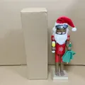 Detail view of 38cm wooden Santa nutcracker soldier standing next to a cardboard box - Santa Claus