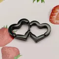 Detailed macro view of black titanium steel heart-shaped ear clips on a cute background - Heart Shape Black (Single Piece)