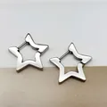 Detailed shot of silver star-shaped titanium steel hoop earrings on minimalist background - Five-pointed Star Steel Color (Single Piece)