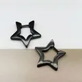 Close-up of black titanium steel star-shaped hoop earrings on split background - Five-pointed Star Black (Single Piece)