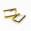 Detailed macro view of elegant gold-finished rectangular titanium steel hoop earrings - Rectangle Gold (Single Piece)