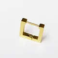 Macro detail view of a minimalist polished gold-finish square titanium steel huggie earring - Square Gold (Single Piece)