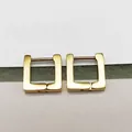 Macro detail of polished gold-finished square hoop earrings made of titanium steel - Square Gold (Single Piece)