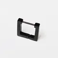 Close-up detail view of a minimalist matte black titanium steel square hoop earring - Square Black (Single Piece)