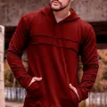 Close-up of burgundy hoodie showing raw-edge chest stitching and hood drawstrings. - M / Red