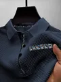 Close-up view of navy blue mesh ice silk polo shirt featuring paisley trim details - S / Navy Blue