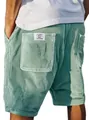 Detailopname van vintage mintgroene corduroy korte broek met een geborduurd zaklabel - Lichtgroen