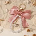 Large pink satin bow keychain with elegant white pearl bead charm and gold ring - Pink (ZJ16874)