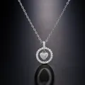 Macro view of silver heart necklace with pavé-set crystals in a circular pendant - Silver