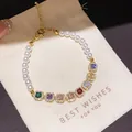Elegant gold-tone bracelet featuring white pearls and square multi-colored zircon stones - Style 3 Bracelet / Gold Multicolor
