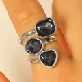 Silver ring set with three black faceted stones in heart, circle, and rectangle shapes. - Silver Irregular Three-Stone Segmented Ring (10)