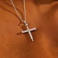 Detailed view of a silver nail-style cross necklace with shimmering zircon stones. - Nail Cross Necklace / Silver