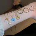 Elegante collana con pendente a fiore in zircone placcato oro 18k e set di anelli - Set di Gioielli Multi-Stile