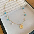 Dettaglio collana placcata oro 18k con turchese, perle e ciondolo a moneta con toro. - Collana con Rilievo di Moneta