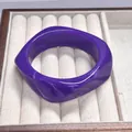 Chunky purple resin bangle with white marble texture in a geometric curved design - Deep Purple Swirl