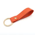 Premium minimalist orange PU leather keychain featuring a polished golden ring holder - Orange & Gold