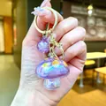 Creative purple mushroom keychain featuring a glitter resin pendant for stylish bags - Gold Hardware Electroplated Mushroom / Aurora Purple