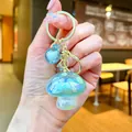 Sparkling iridescent mushroom keychain charm for bags with gold-tone metal ring - Gold Hardware Electroplated Mushroom / Aurora Green